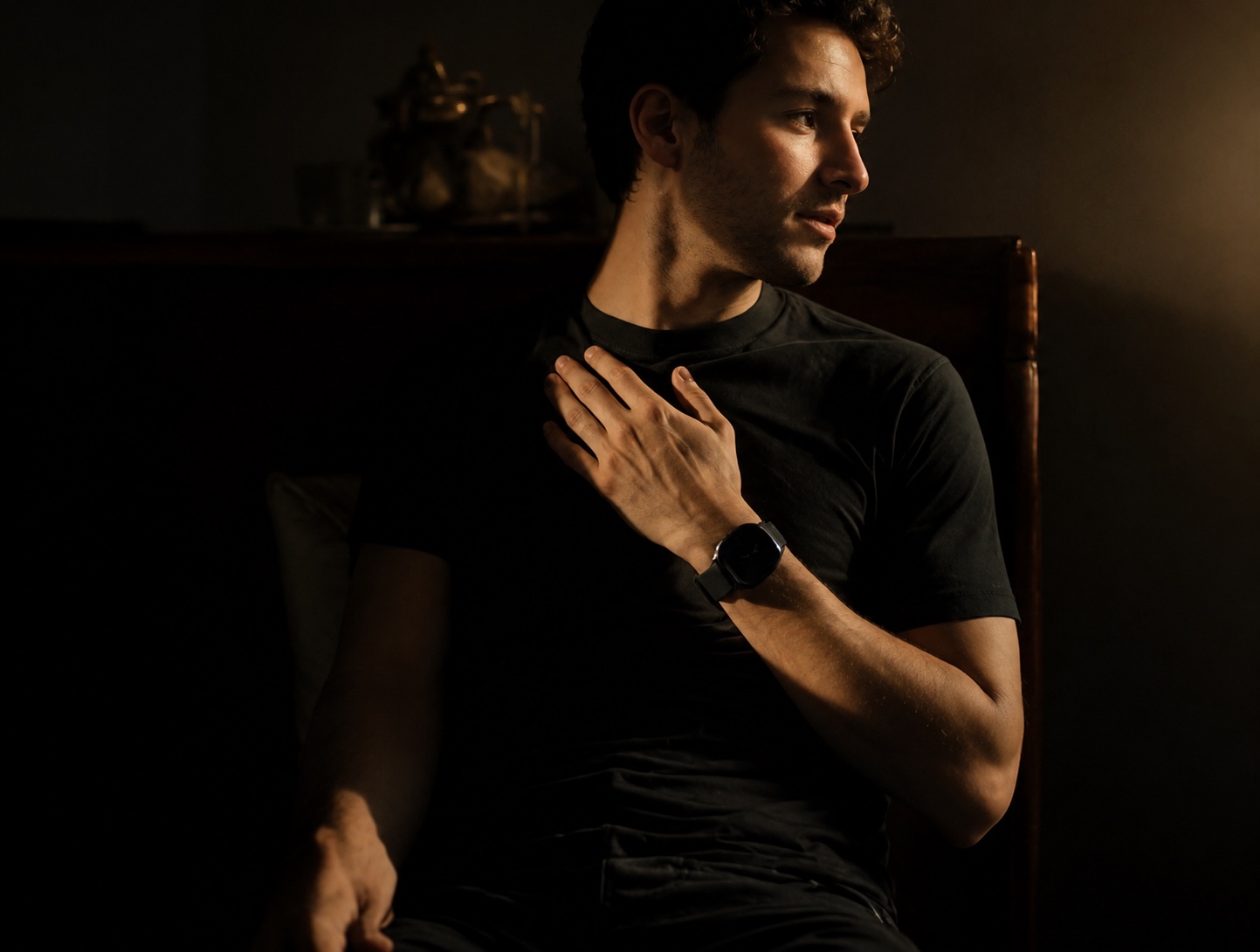A man in soft evening light sensing his heartbeat